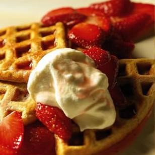 Waffles with Strawberries and whip cream.