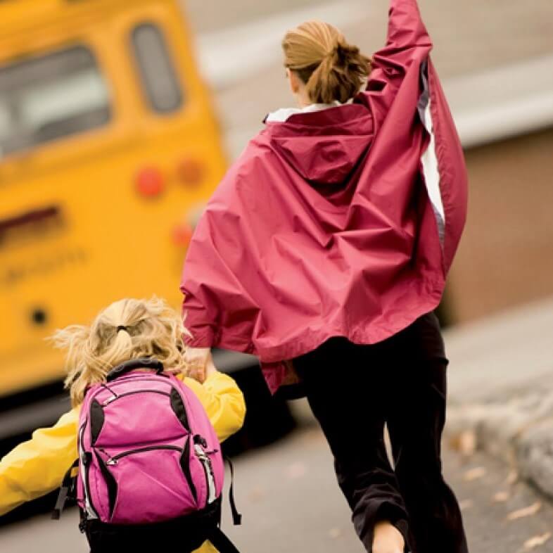 mom and daughter running to bus